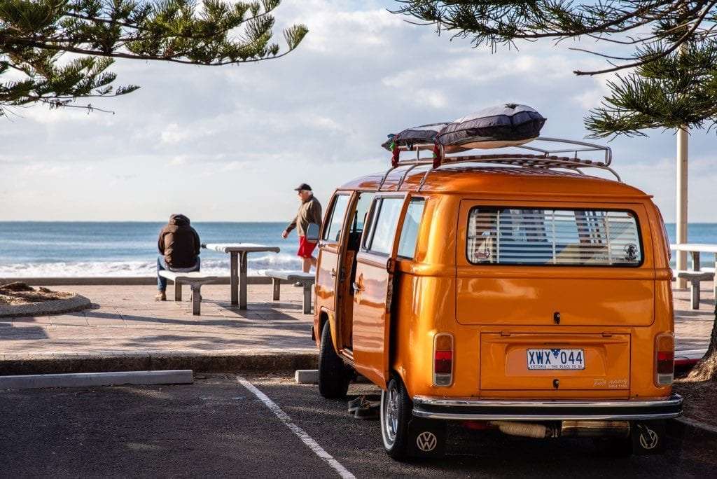 A van parked near the ocean