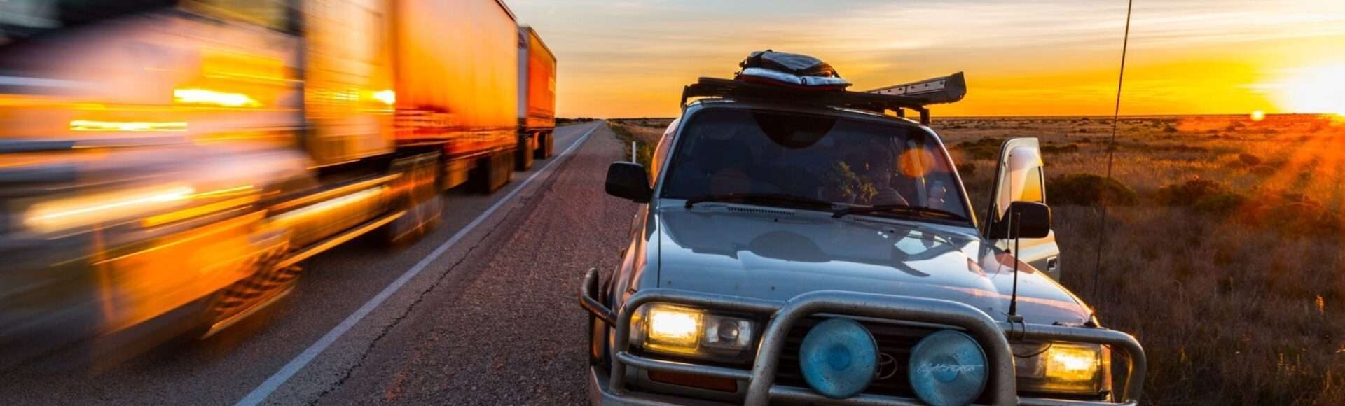 A car with roof rack parked on the side of the road