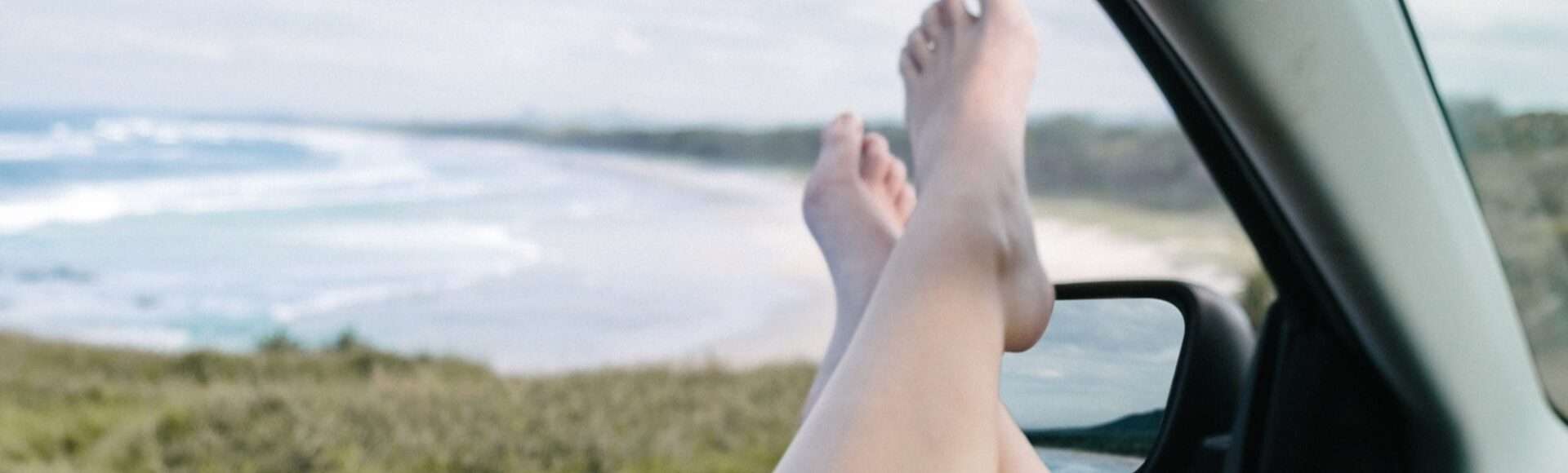 Feet on a car window