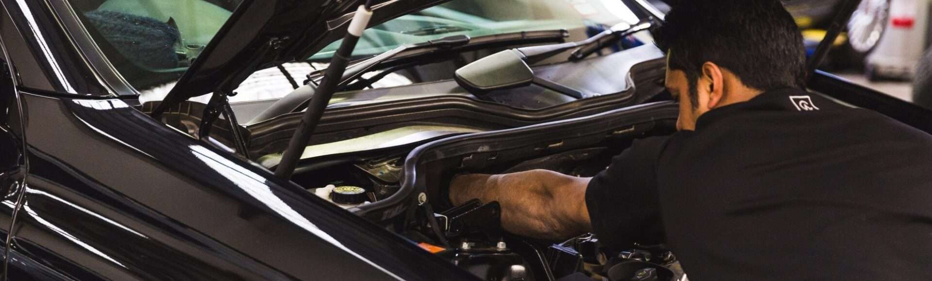 Mechanic replacing a faulty part