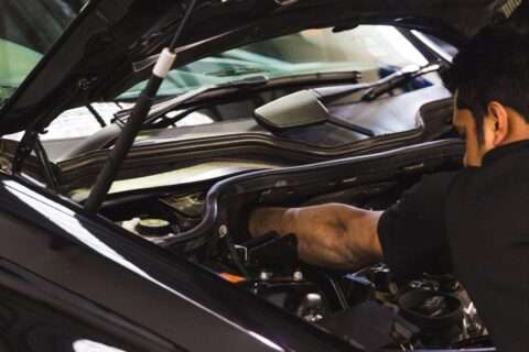 Mechanic replacing a faulty part