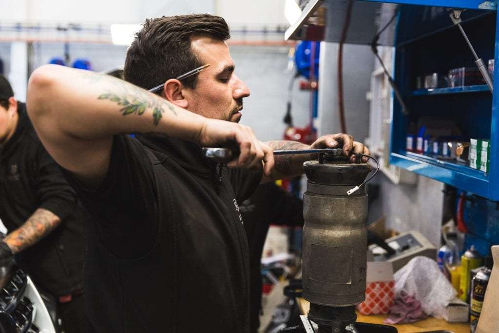 Mechanic fixing a car part