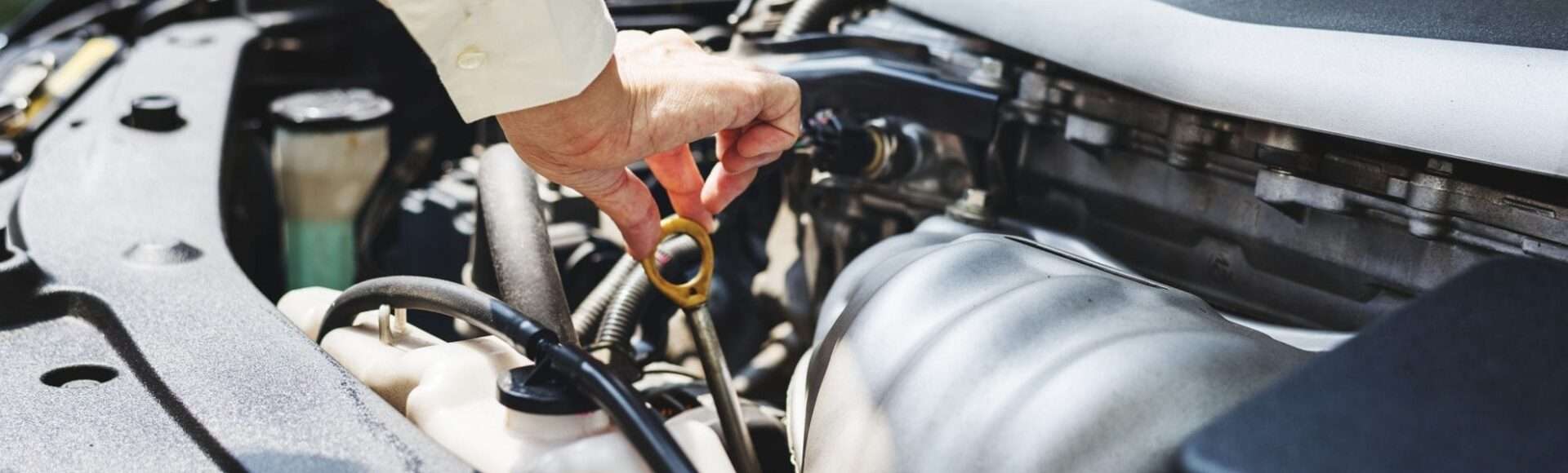 A person checking the oil level