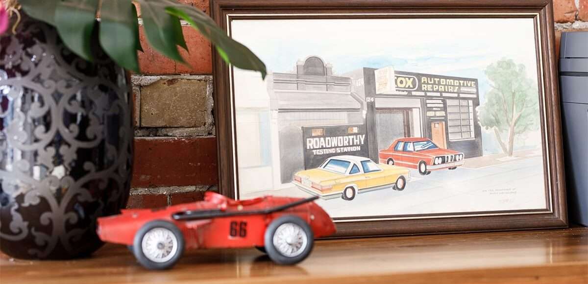 Cox Auto sketch on a shelf