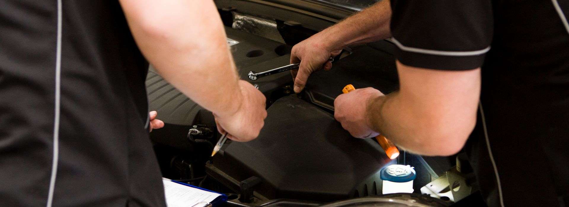 Auto repairmen fixing a car