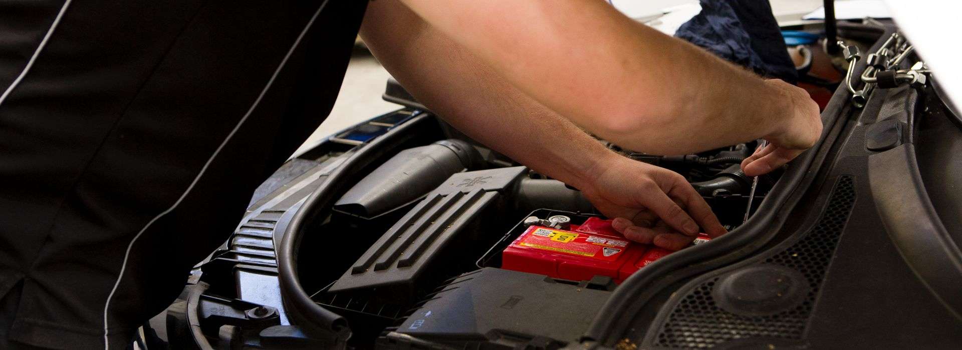 Auto mechanic troubleshooting a vehicle