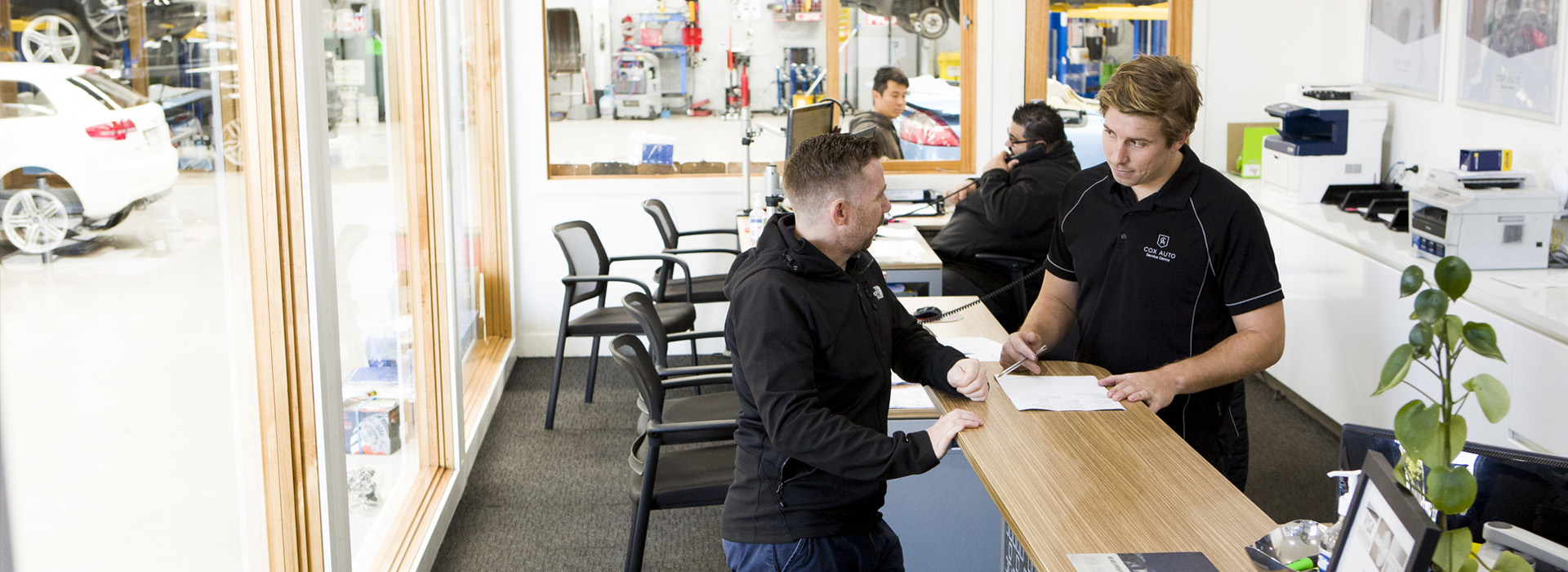 Mechanic talking to a customer
