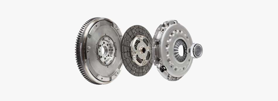 Isolated view of a car clutch kit showing the flywheel, clutch disc, pressure plate, and release bearing.