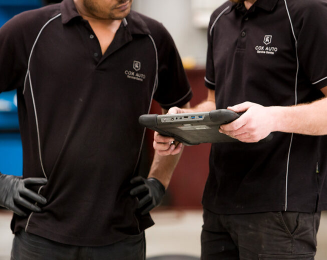 Mechanics looking at OBD scanner