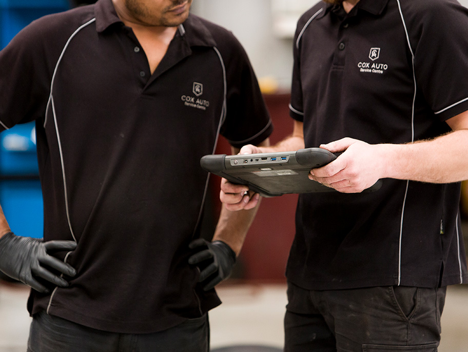 Mechanics looking at OBD scanner