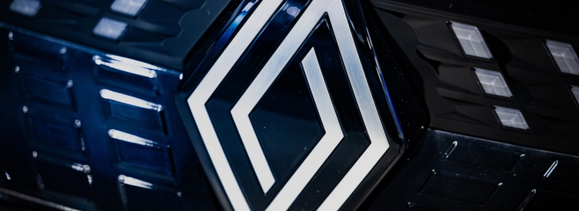 Close-up of the illuminated modern Renault logo.