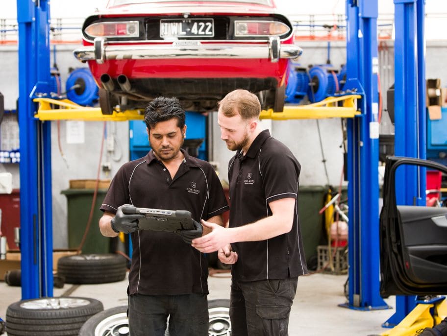 Two mechanics look at an OSB scanner